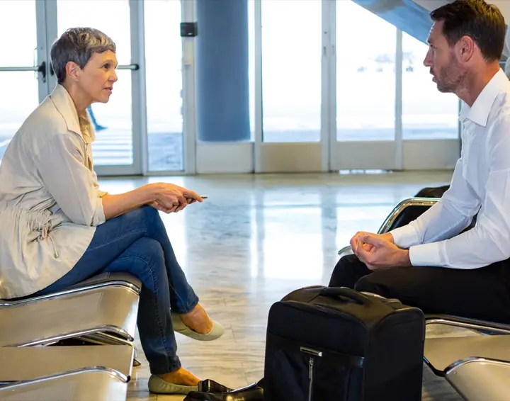 Travelers meeting and talking before a flight