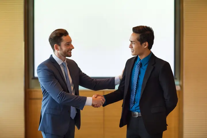 Professionals shaking hands after connecting